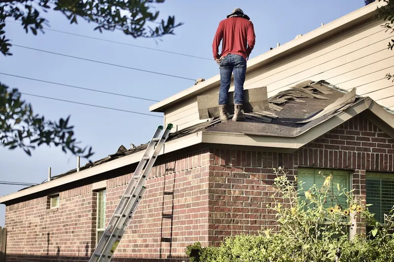 Professional roofer working on a residential roof in Loudon